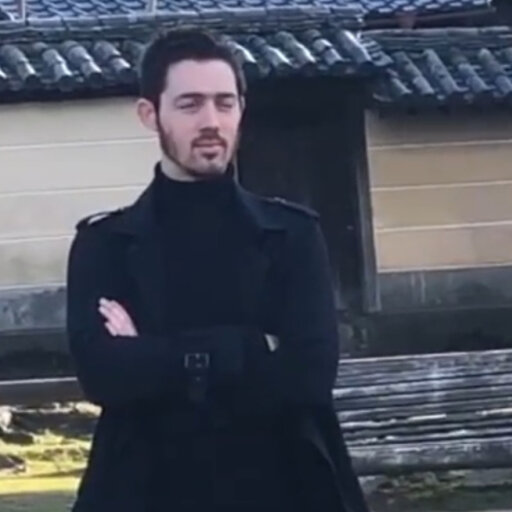 picture of a man with crossed arms in a japanese field